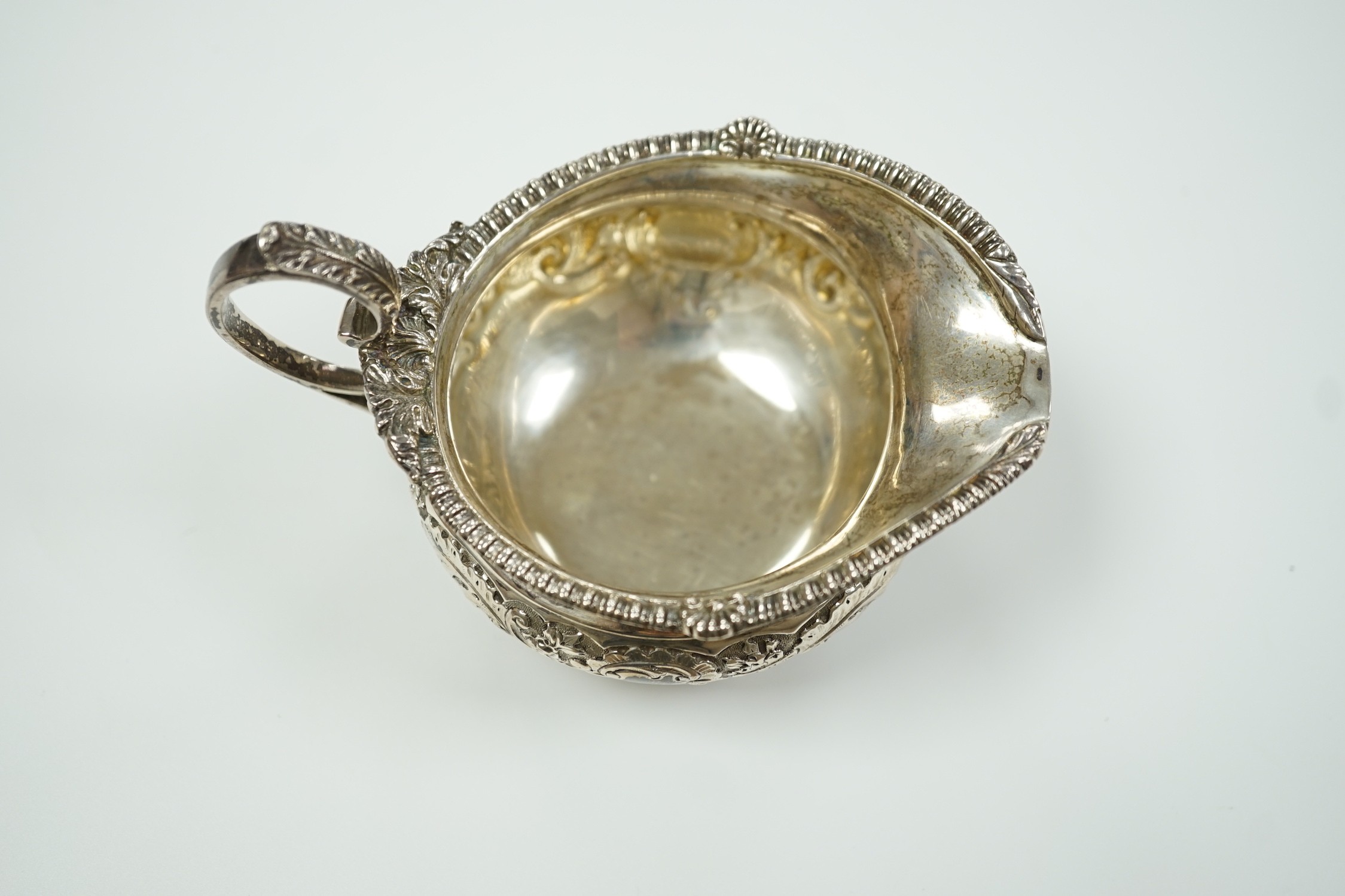 A late Victorian embossed squat silver cream jug, Edward Barnard & Sons, London, 1898, height 74mm, 4.6oz.